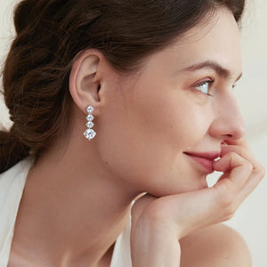 Silver cascade cubic zirconia drop earrings with four sparkling stones.