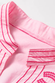 Pink cotton shirt with contrast embroidery detail on collar and placket.