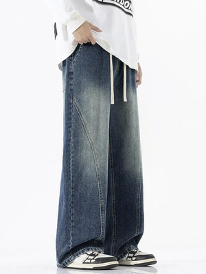 Relaxed fit wide-leg jeans in dark wash denim with drawstring waist and contrast stitching.