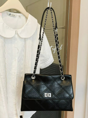 black handbag with quilted and null