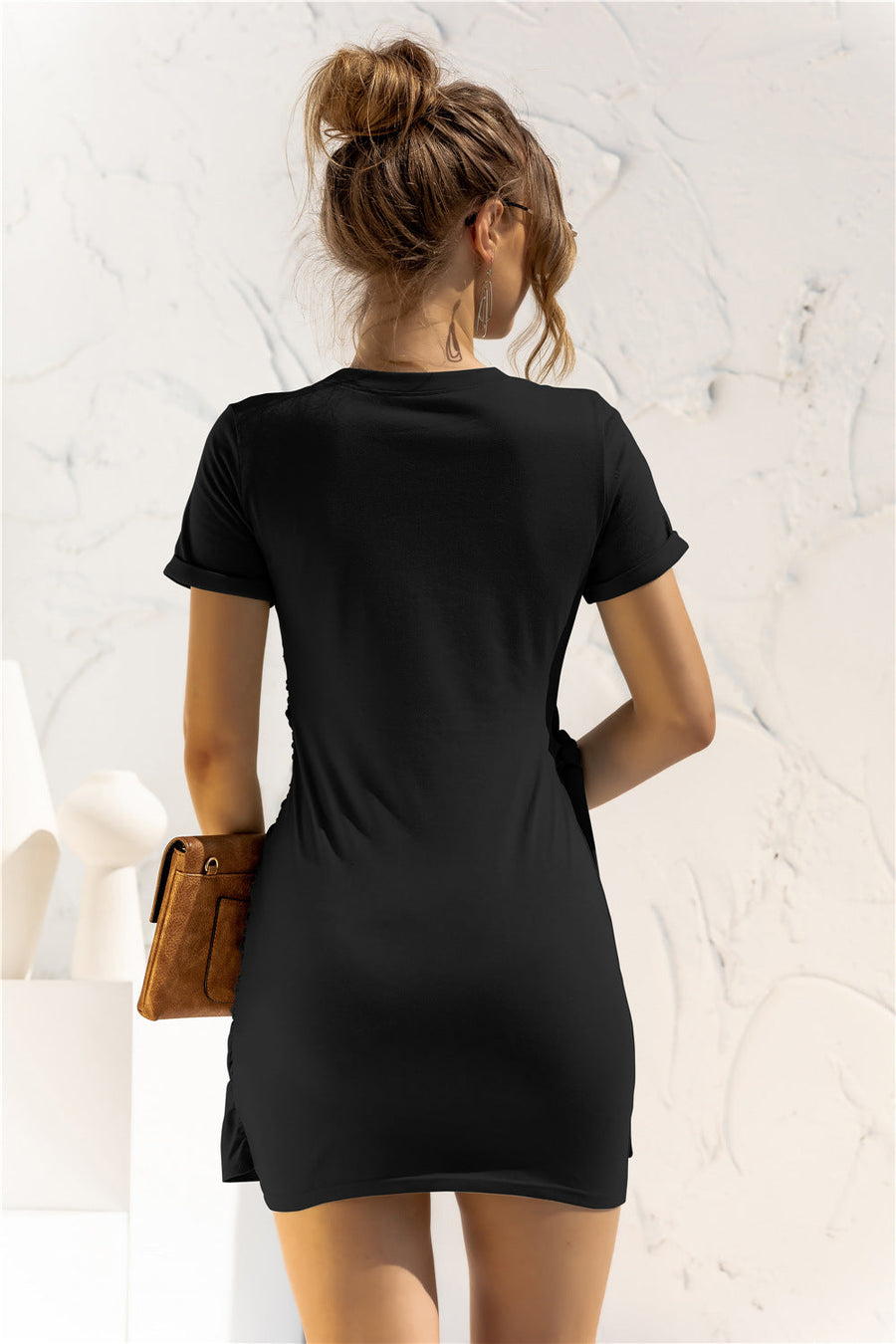 Black jersey mini dress with knot-front detail and short sleeves.