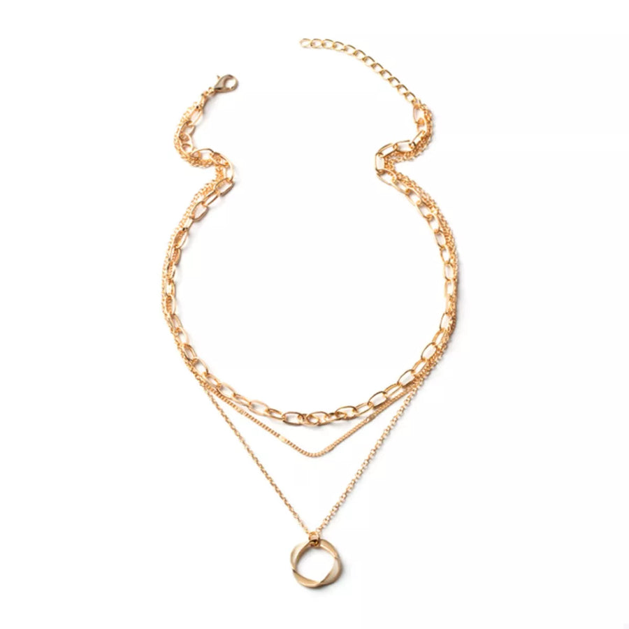 Gold layered necklace with a circular pendant and mixed chain styles