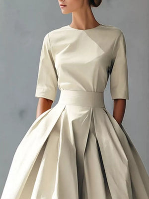 Chic white A-line midi dress with a pleated skirt and three-quarter sleeves.