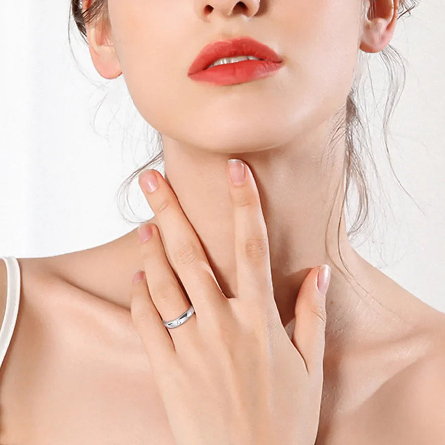 Silver baguette cut moissanite band ring on a woman's finger