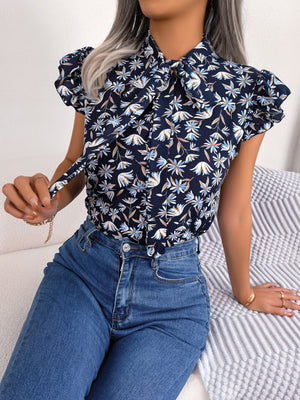 Dark blue floral blouse with neck-tie and ruffle sleeves