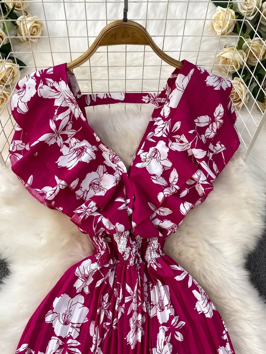 Rose Red floral print romper with ruffled sleeves and smocked waist.