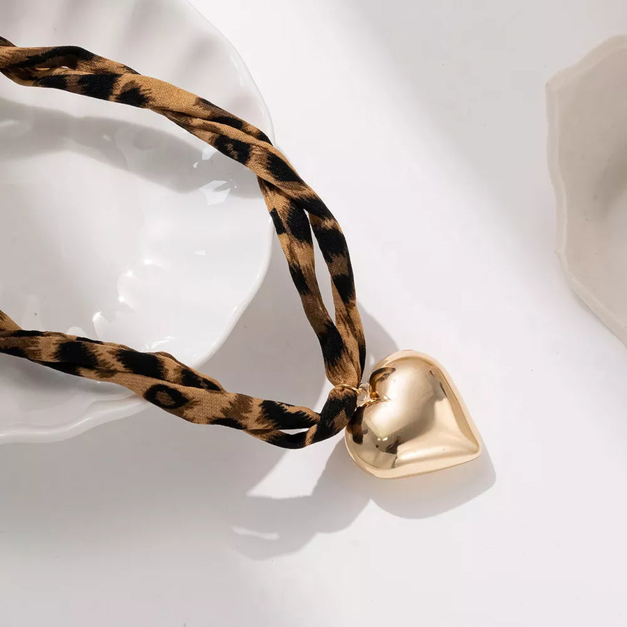 tan necklace featuring pendant and leopard