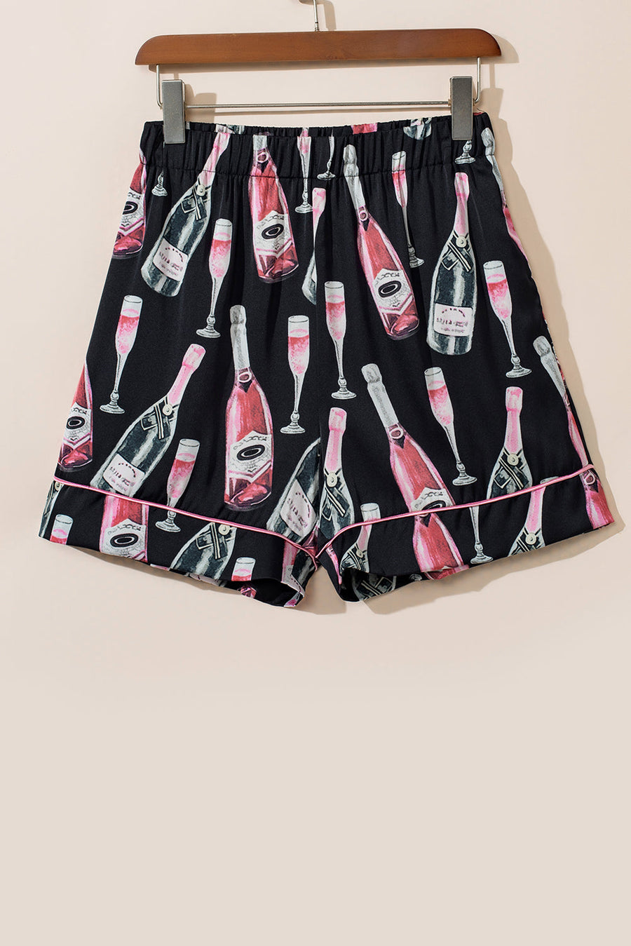 Black silk pajama shorts with champagne bottle and glass print, pink piping detail.