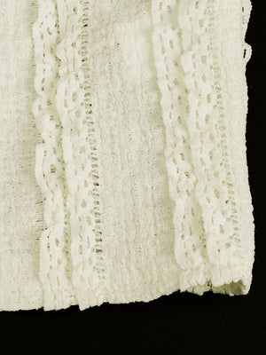 White textured cami top with sweetheart neckline and lace trim detail.