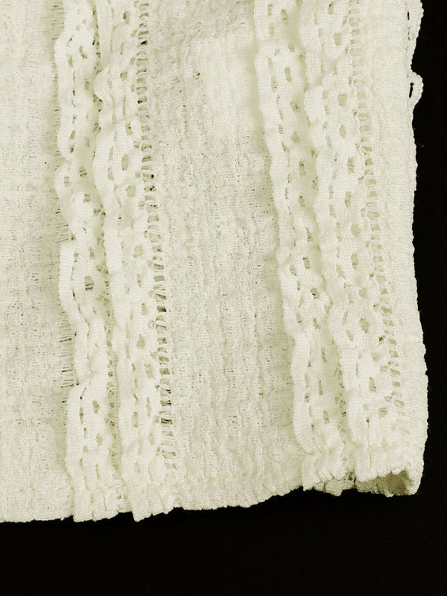 White textured cami top with sweetheart neckline and lace trim detail.