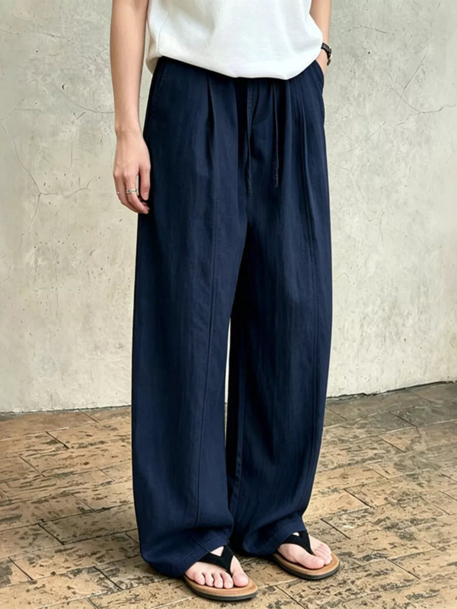 Dark blue wide-leg sweatpants with drawstring waist and pockets.