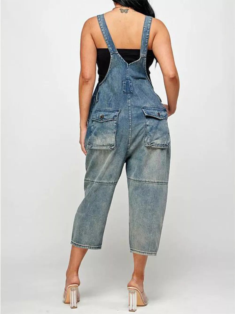 Light blue denim overalls with button front, adjustable straps, and multiple pockets.