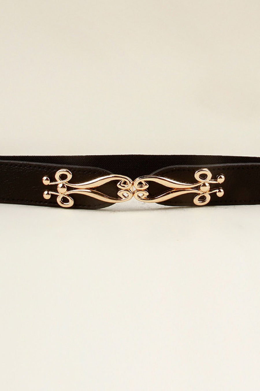 Black elastic belt with a sculpted gold alloy clasp closure.