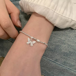 silver bracelet with butterfly motif and n/a