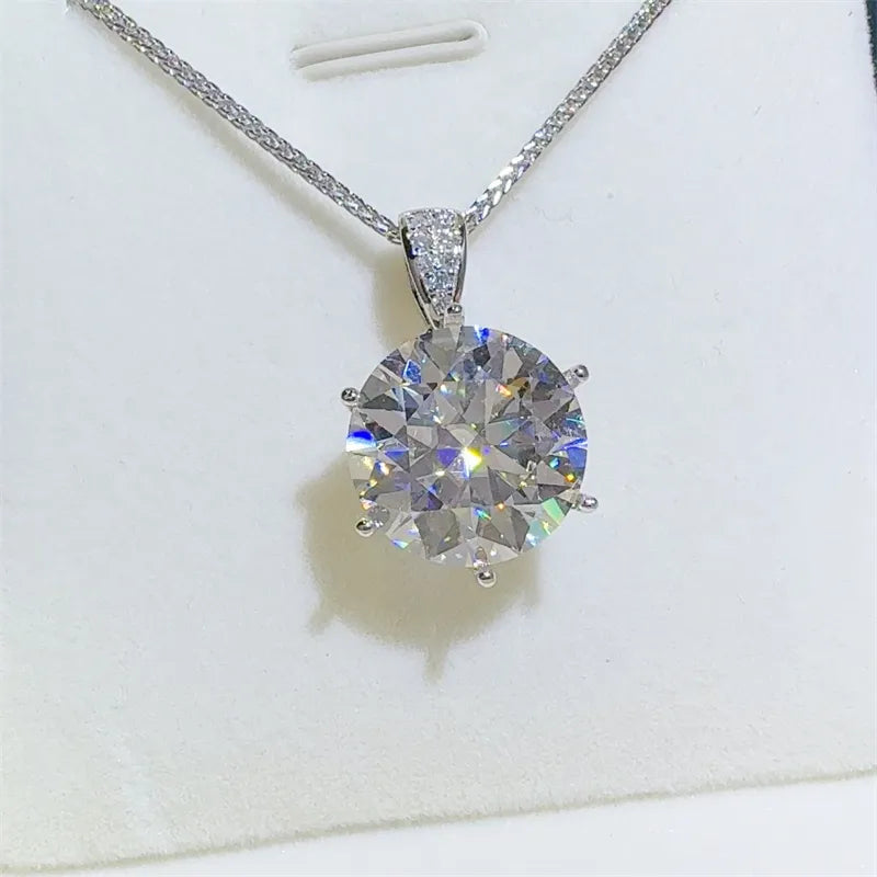 Silver moissanite solitaire pendant with a large, brilliant-cut stone and a delicate chain.