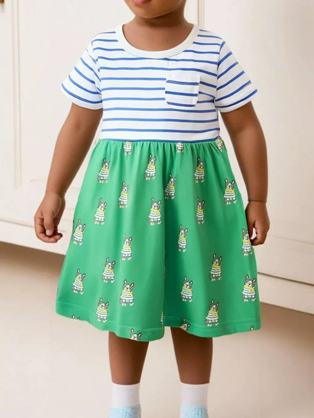 Baby dress with blue stripes and dog print skirt, short sleeves, crew neck, and chest pocket.