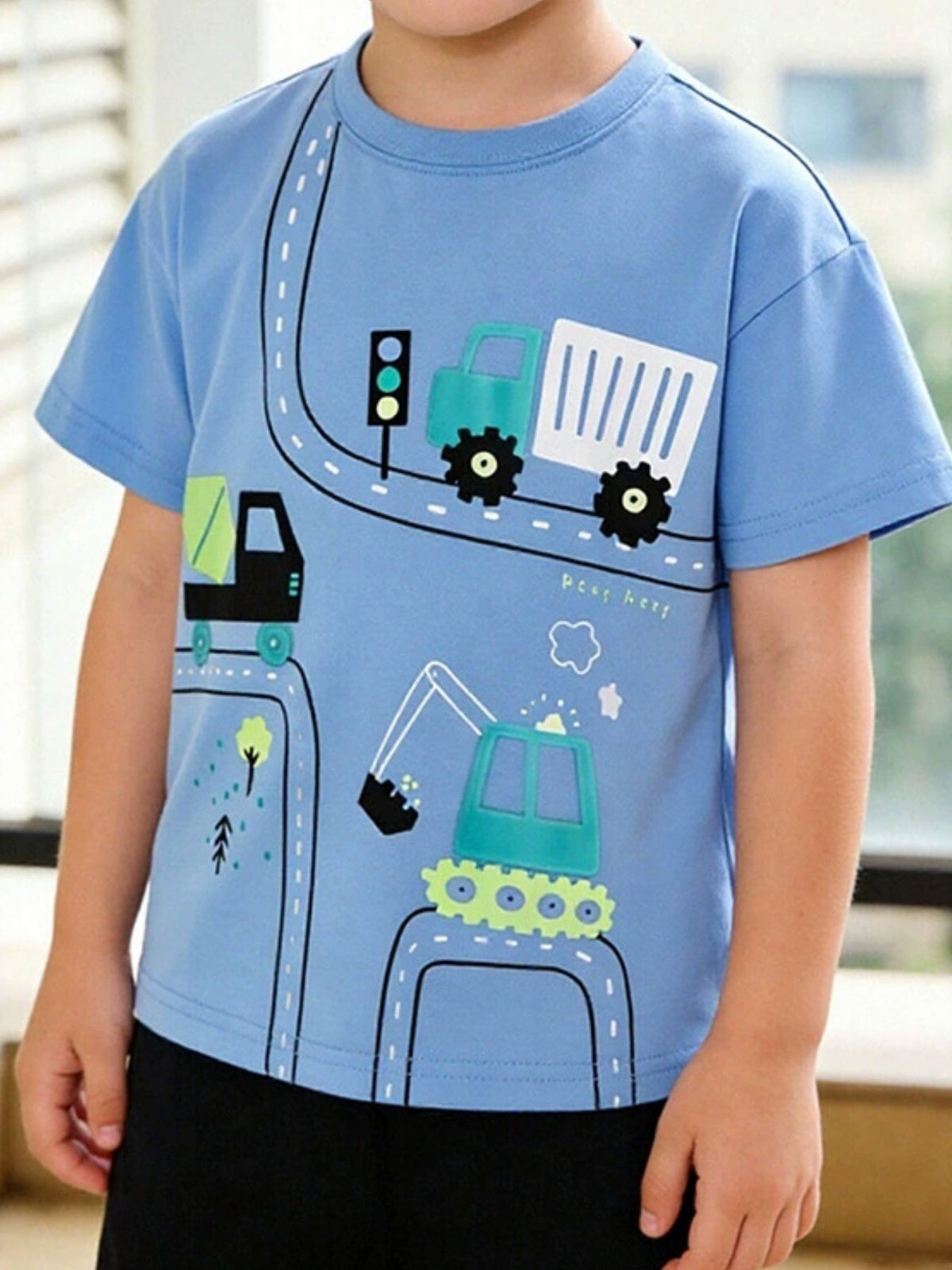 Blue crew neck t-shirt with playful construction vehicles and road graphic for toddlers.