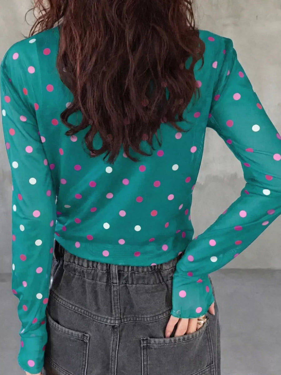 Sheer polka dot mock neck shirt in Air Force Blue with pink and white dots, long sleeves.