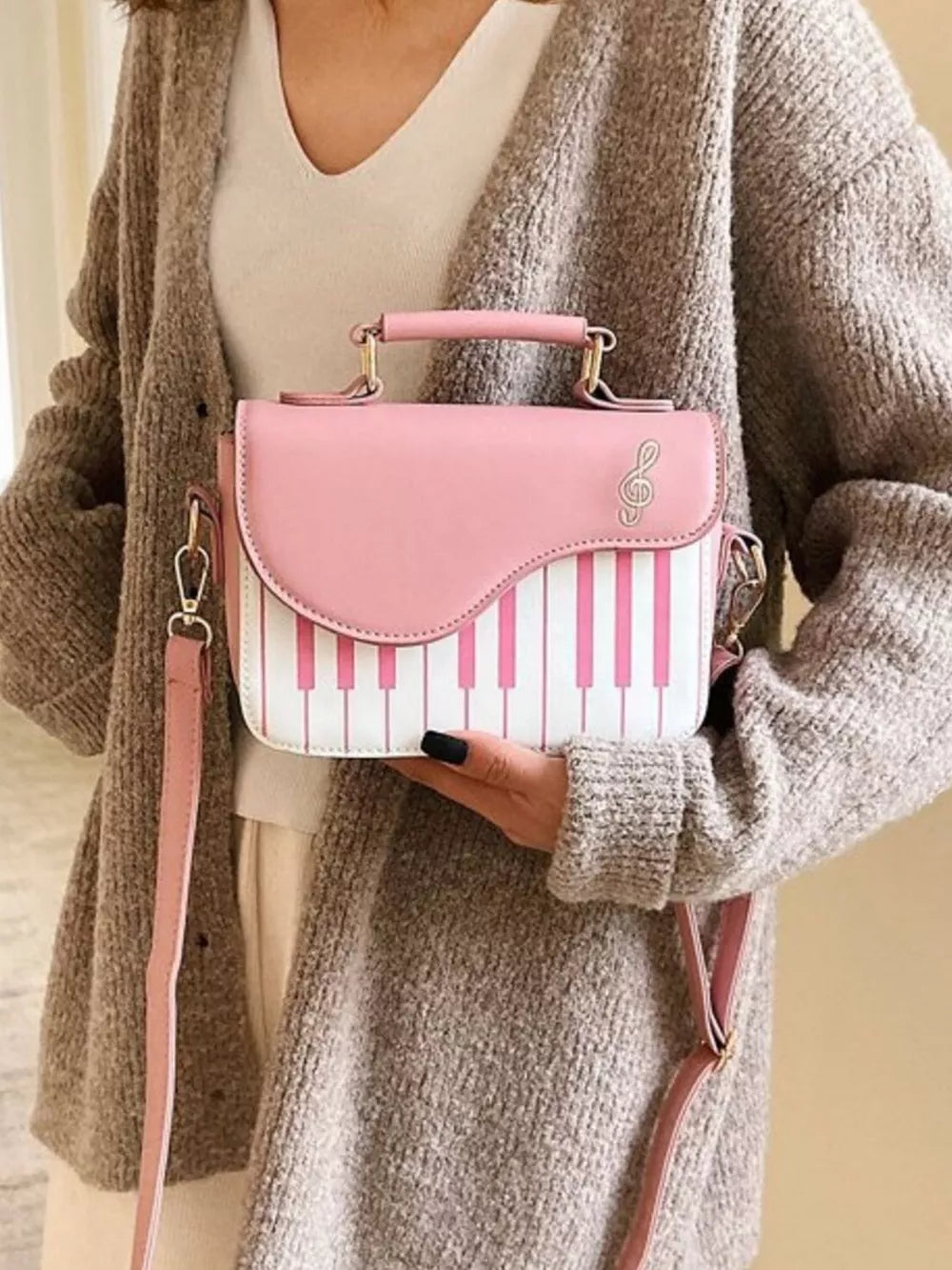 Pink and white piano key crossbody bag with musical note detail