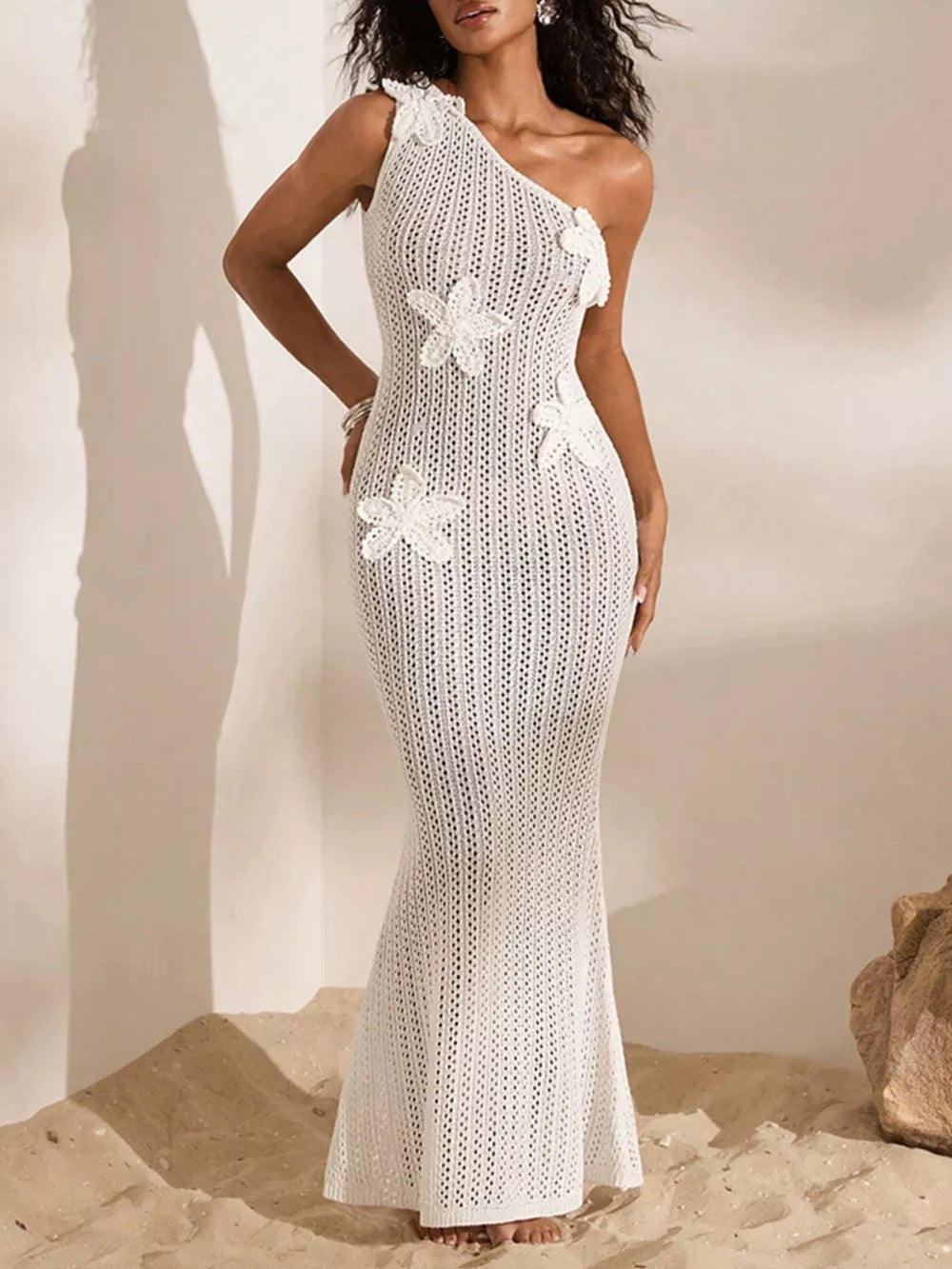 White crochet one-shoulder maxi dress with floral appliques and a mermaid hem