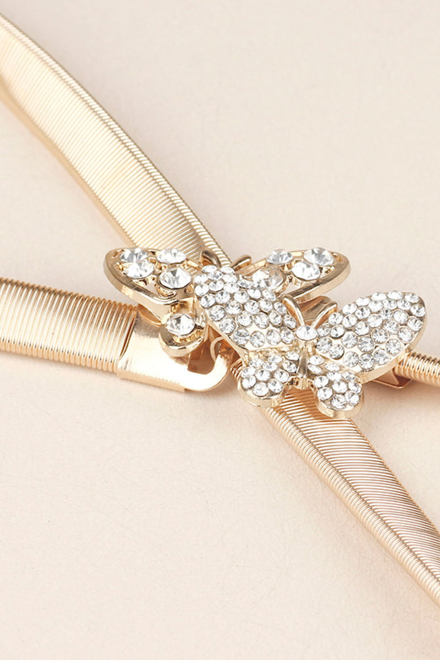 Gold elastic belt with a crystal-embellished butterfly clasp