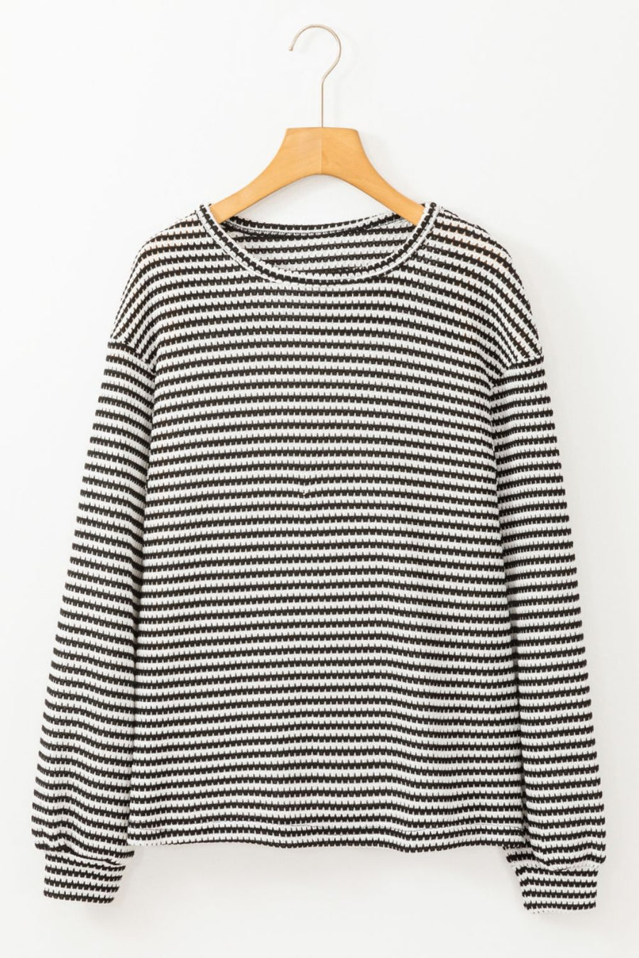 Textured stripe balloon sleeve top in black and white with a crew neck.