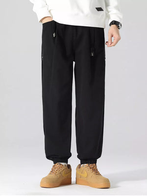 Black oversized cargo joggers with drawstring waist and elastic cuffs.