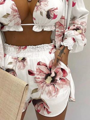 Floral print two-piece outfit set with ruffled trim and smocked cuffs, ivory with pink flowers.