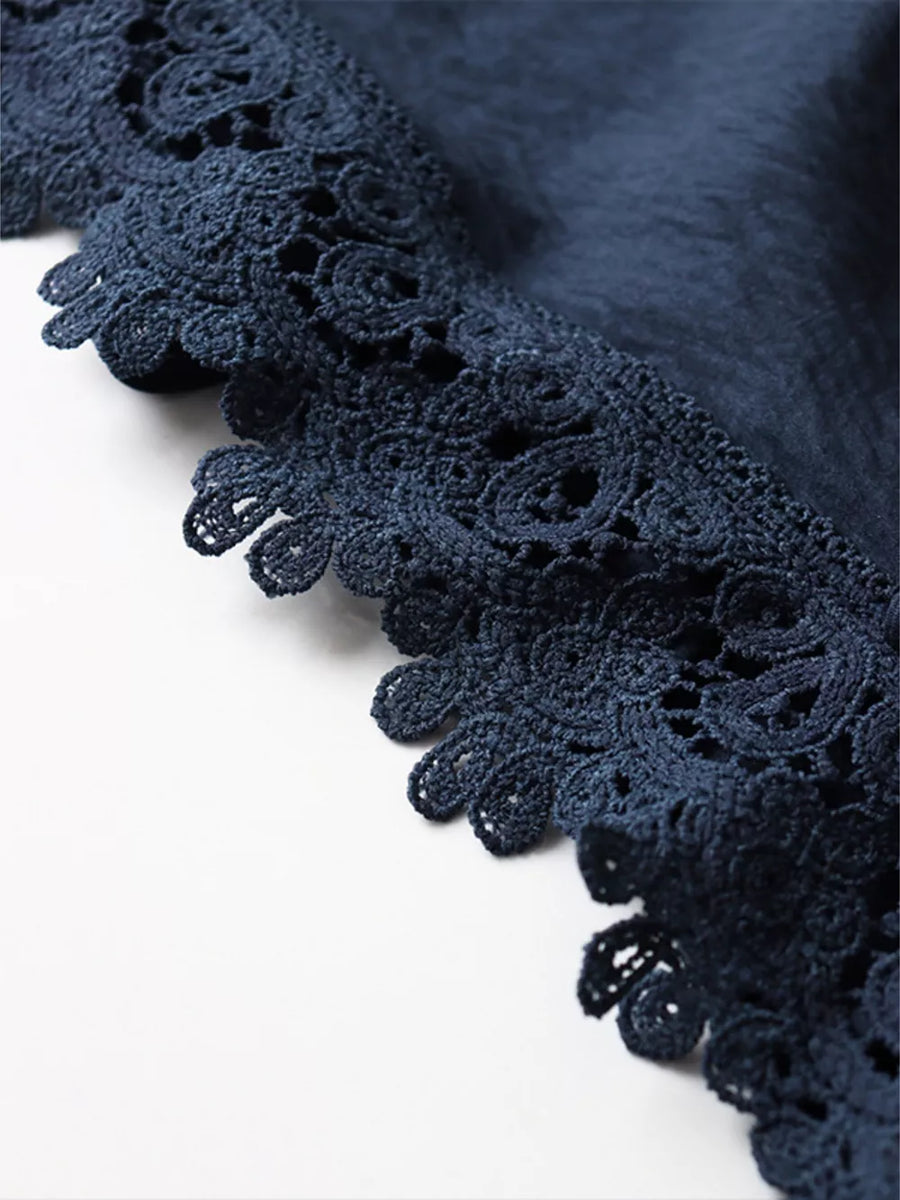 Navy blue fabric with intricate crochet lace trim detail
