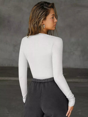 Gray/white long-sleeve top with deep V-neck and cutout detail