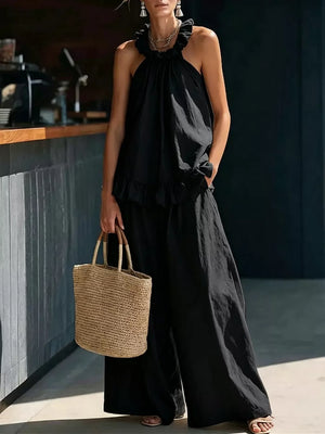 Black ruffled halter neck top and wide-leg pants set with frill detail.