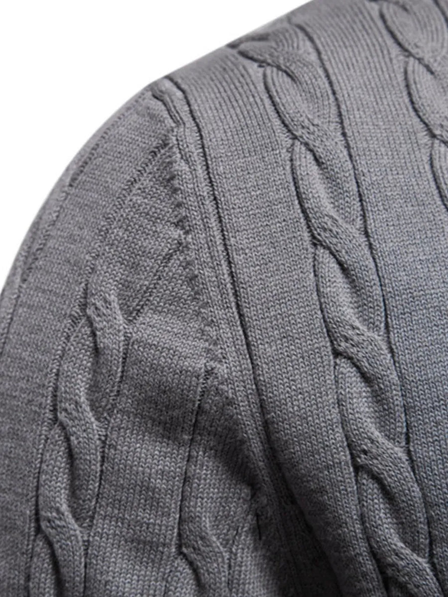 Gray cable knit crewneck sweater with textured knit details.