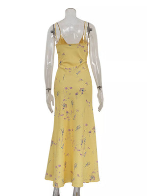 Yellow floral print slip dress with spaghetti straps and a midi length.