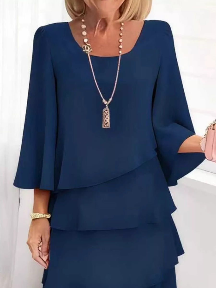 Dark blue tiered dress with 3/4 bell sleeves and scoop neckline.