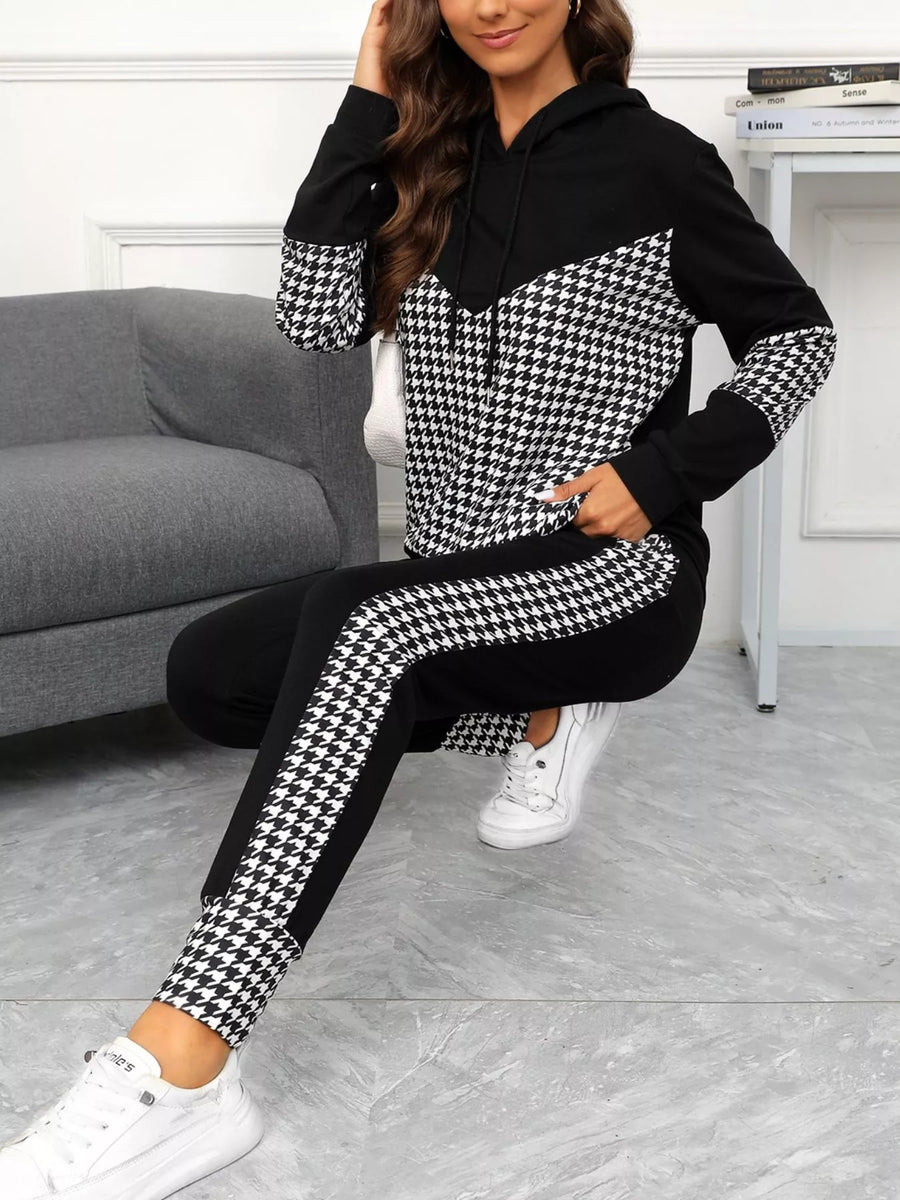Black houndstooth hoodie and pants set with drawstring detail and contrast panels.