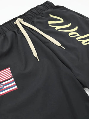 Black active shorts with drawstring and Wolves script logo, featuring a flag patch.