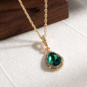 18K gold-plated necklace with dark green teardrop crystal pendant surrounded by small clear crystals.