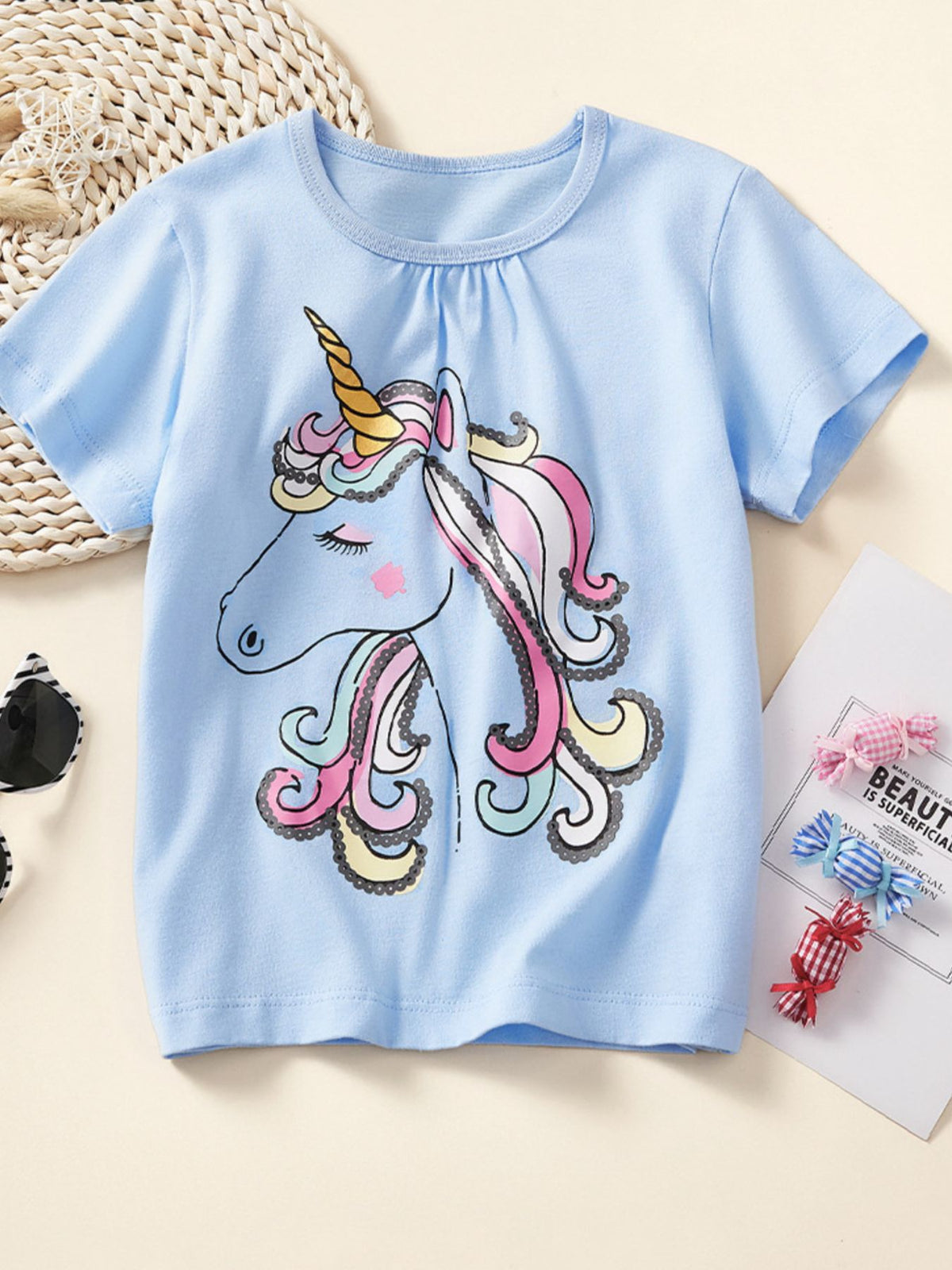 Light blue cotton crew neck t-shirt with a colorful unicorn graphic.