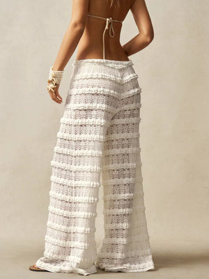 White crochet pants with tiered ruffles and a wide leg.