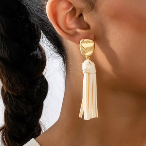 earrings in gold featuring tassel detail and dangle fit