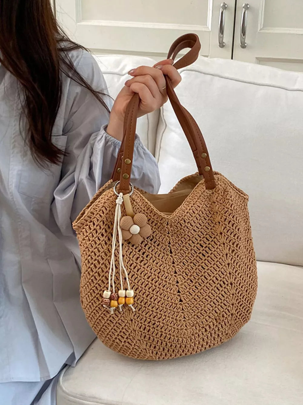 shoulder bag in tan featuring crochet knit construction and relaxed fit