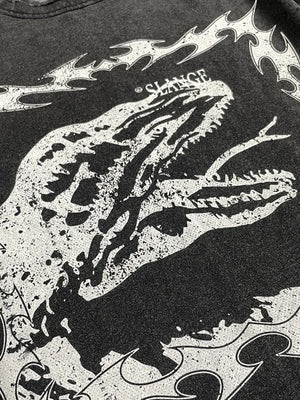 Black distressed graphic tee with a white dinosaur motif and tribal flames.