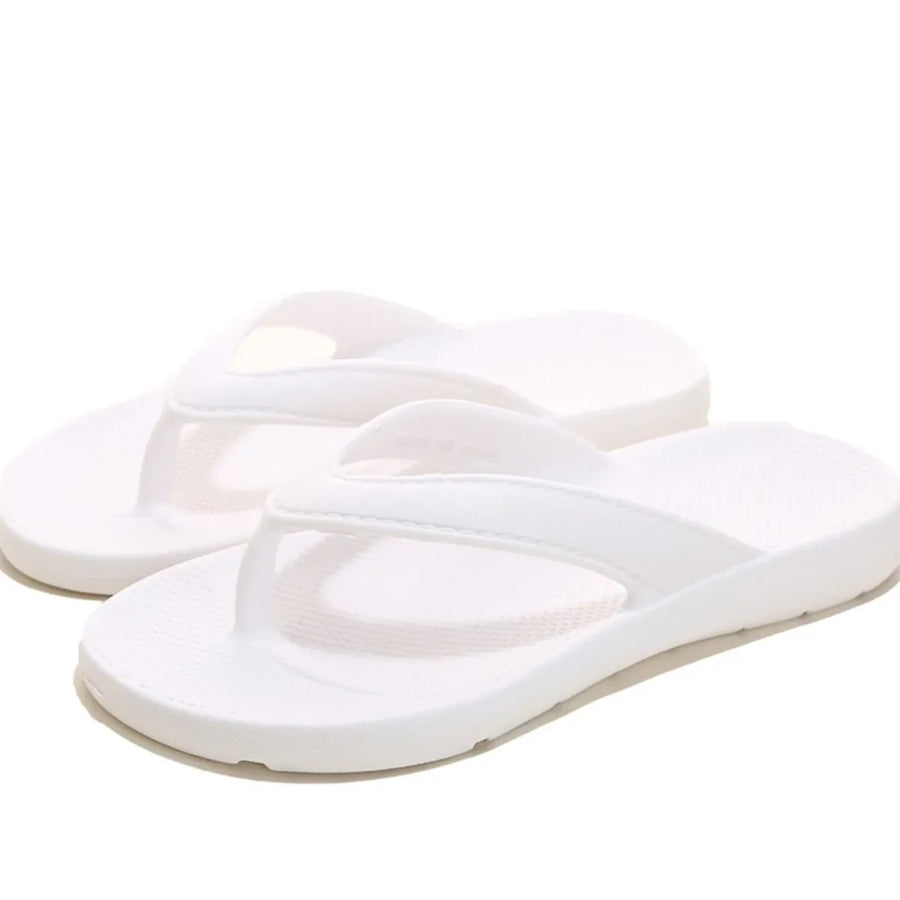 White textured rubber thong sandals with a casual beach style.