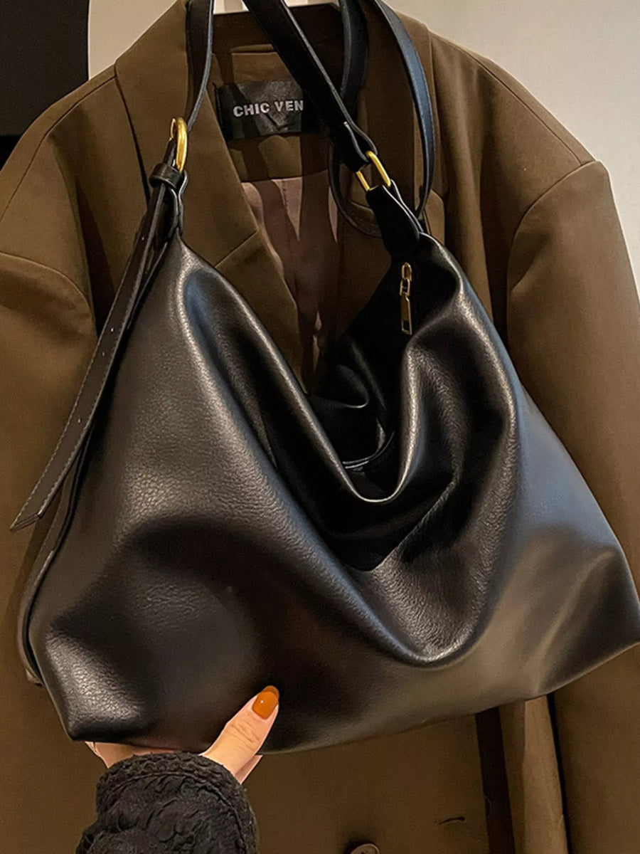 Black sculptural PU leather shoulder bag with adjustable strap and gold hardware