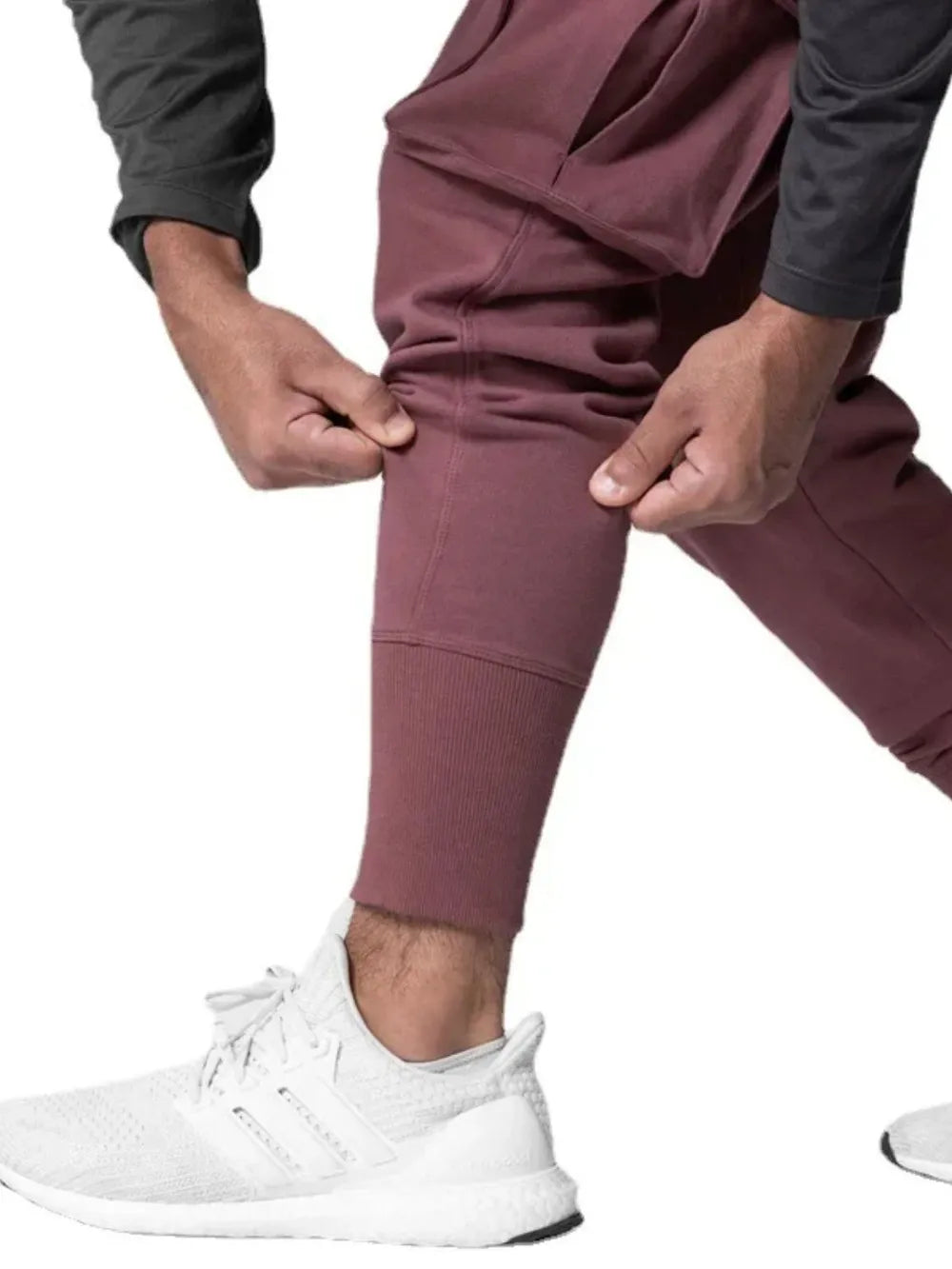 Dusty pink Tech-Knit cargo joggers with ribbed cuffs and a zip pocket detail.