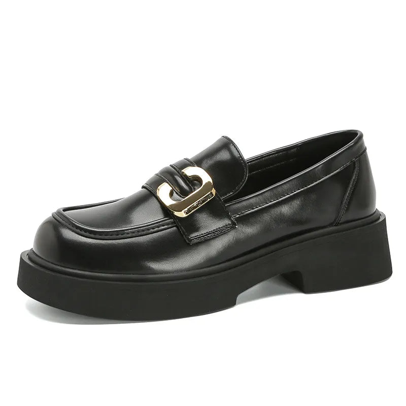 Black patent leather chunky loafers with gold buckle detail and platform sole.