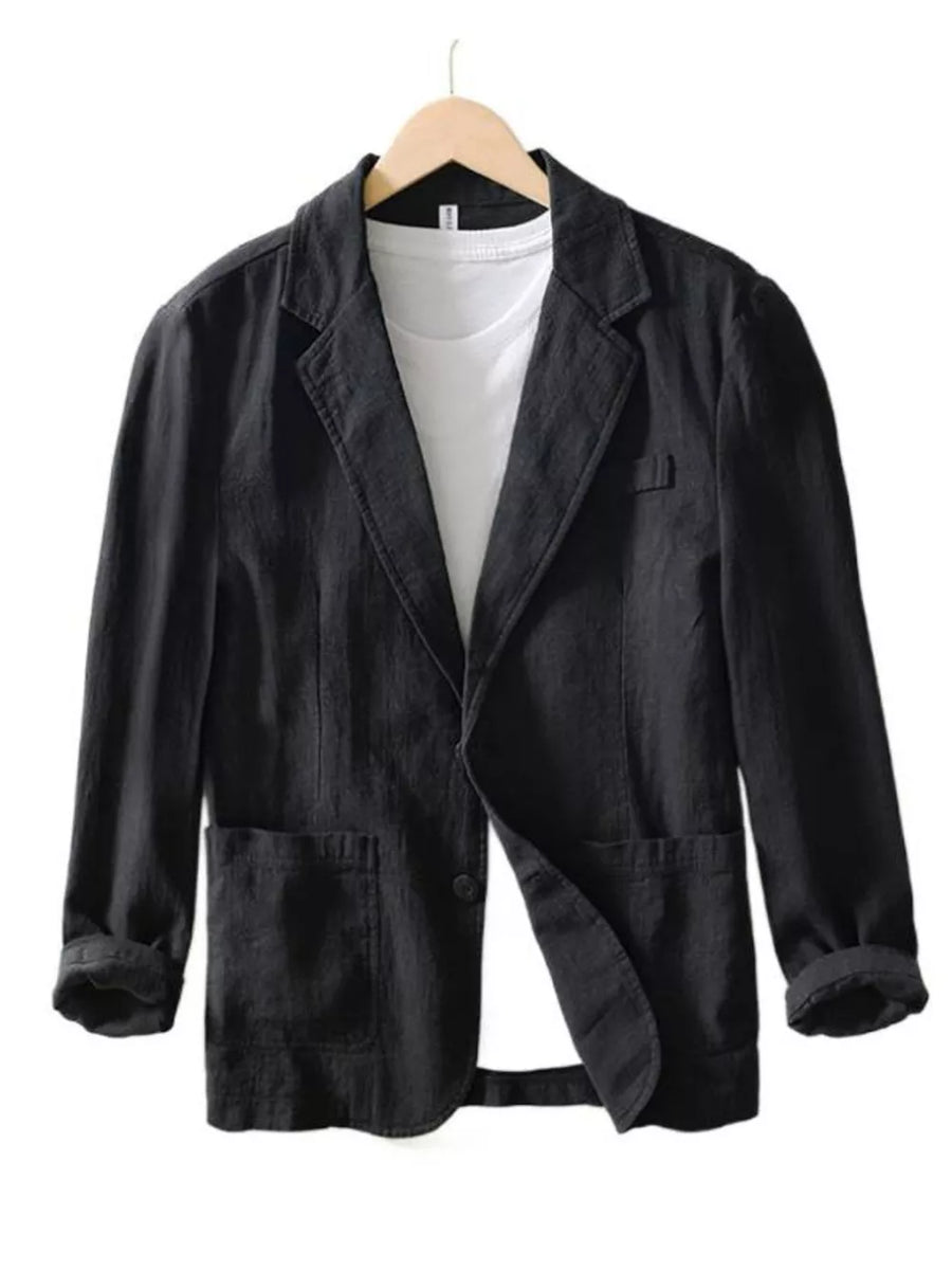 Black long sleeve blazer with lapel collar, two front pockets, and a single button closure, styled over a white t-shirt.