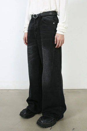 Oversized black wash denim jeans with a wide leg and distressed detailing.
