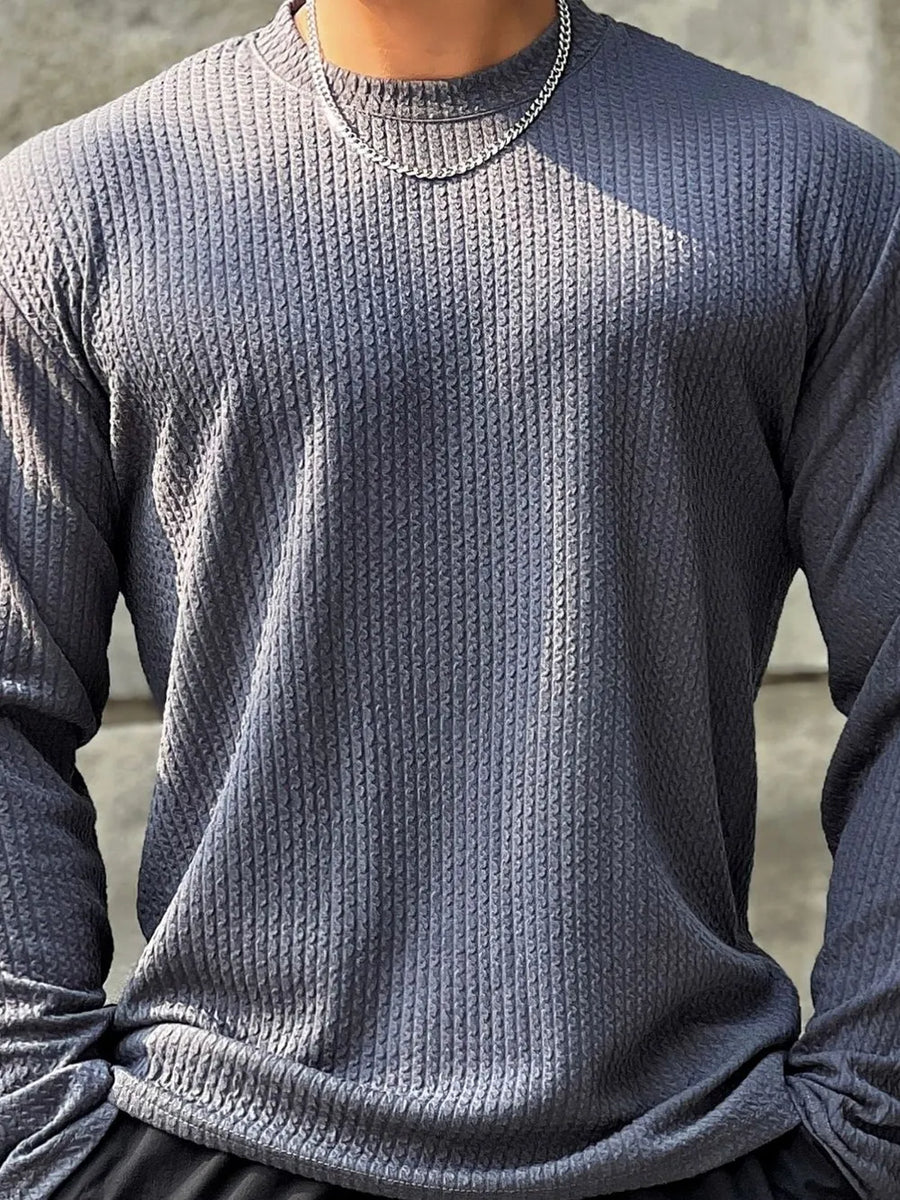 Men's dark gray textured long sleeve tee with round neck and silver chain necklace.