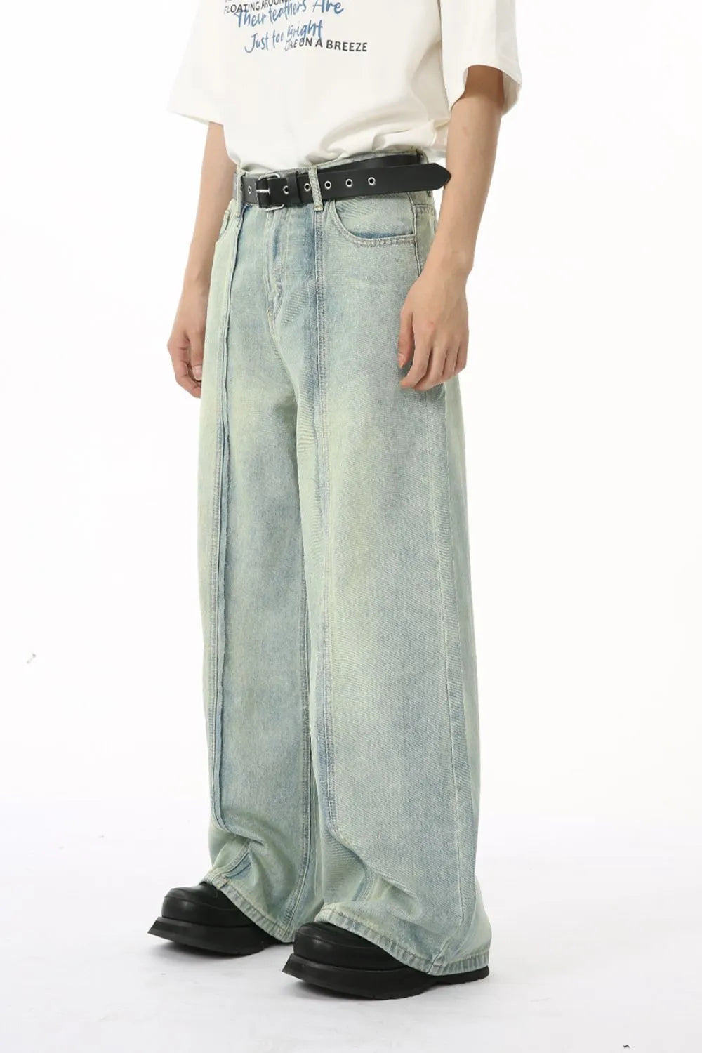 Light wash denim palazzo trousers with vertical seams and a wide leg.